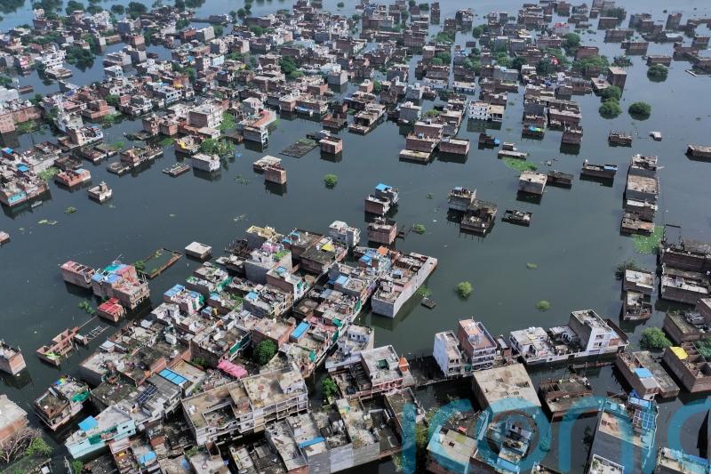 Four killed and dozens trapped under debris as flash floods hit northern India