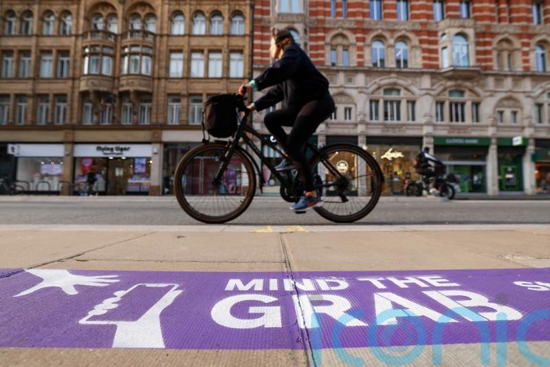 Purple pavement markings part of Mind the Grab campaign to tackle phone theft