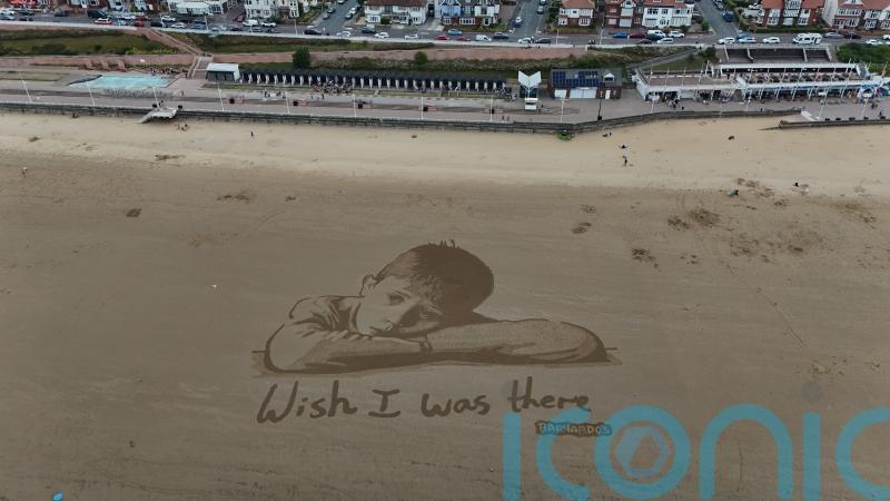 Huge sand artwork highlights how child poverty means millions miss out in summer