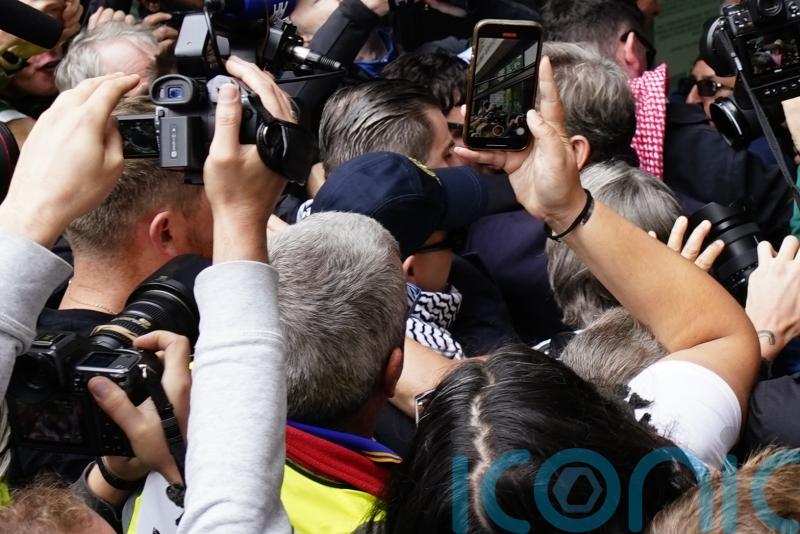 Hundreds greet Kneecap rapper as he arrives at court on terror charge