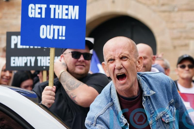 Opposing sides chant and shout outside asylum hotel in Perth