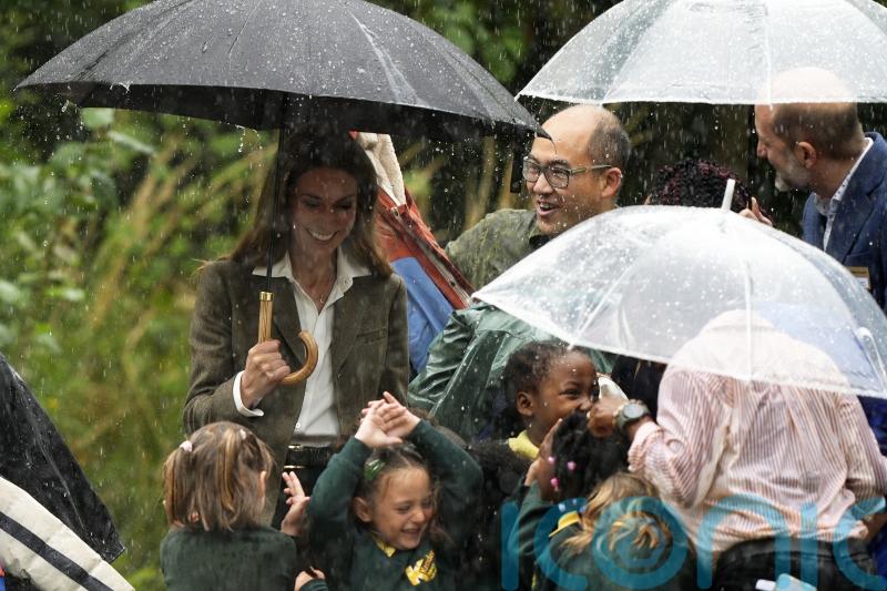 Kate debuts blonde look as she leads schoolchildren out of rainstorm