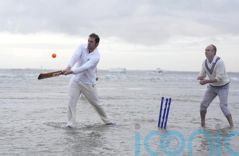 In Pictures: Waterlogged pitch perfect for cricketers playing annual game in sea