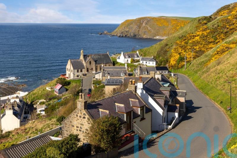 Man in hospital and woman &lsquo;yet to be traced&rsquo; following house fire