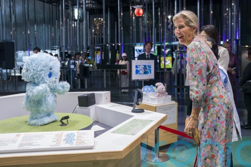 Duchess of Edinburgh interacts with robot dog during Japan visit