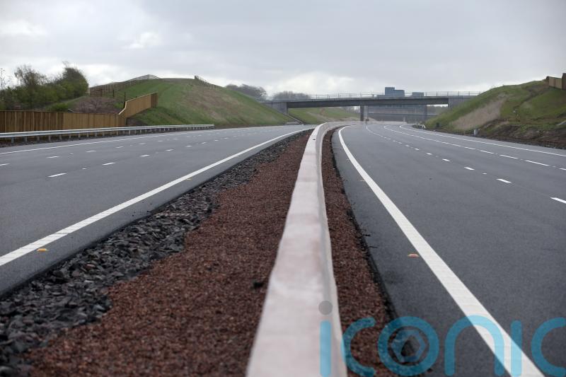 Travel disruption after lorry crash spills ‘shed load of wood’ on M8
