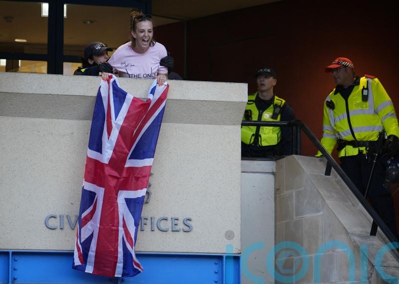 Charges dropped against woman who unfurled flag from Epping council building
