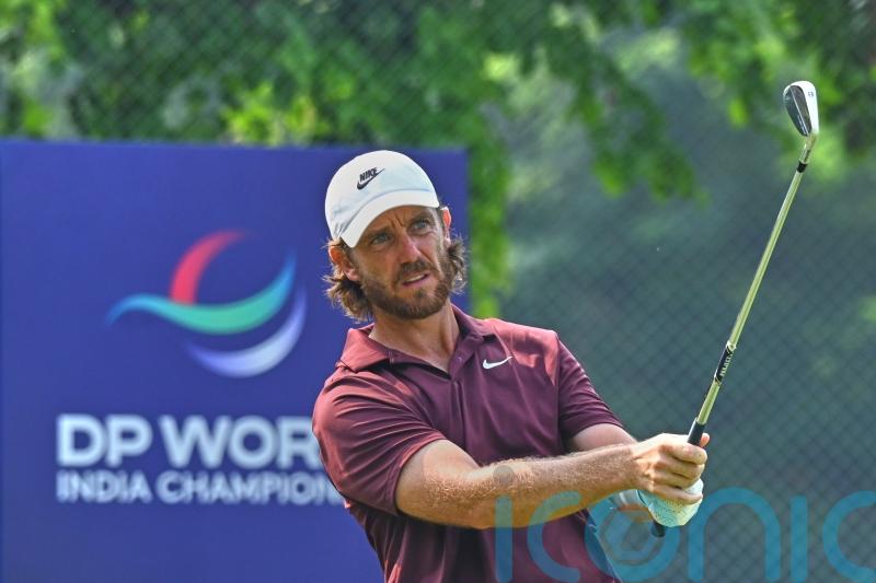 Tommy Fleetwood celebrates with son on 18th green after victory in Delhi