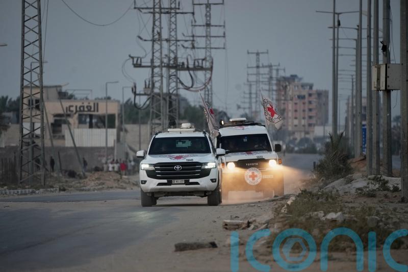 Palestinian militants hand over the remains of two more hostages