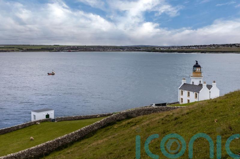 Man spotted clinging to hull of capsized vessel rescued