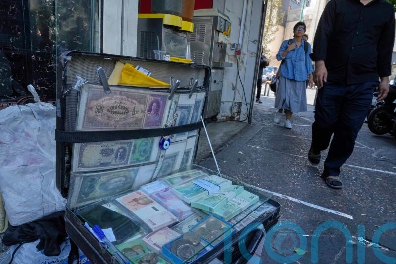 Iran’s currency falls to new low as nuclear sanctions squeeze ailing economy