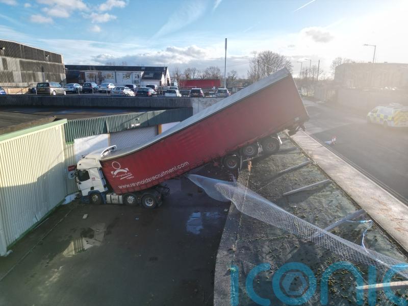 Lorry becomes wedged after crashing down steep bank