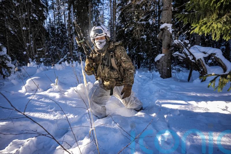 Soldiers wade through &lsquo;chest-deep&rsquo; snow during training close to Russian border