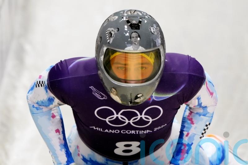IOC urges Ukrainian racer to compete amid row over banned war victim helmet