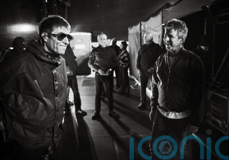 Liam and Noel Gallagher shown having a laugh in Oasis tour photography book