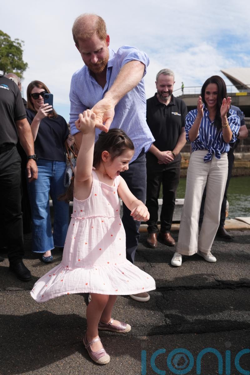 Harry dances with Australian girl before sailing around Sydney Harbour