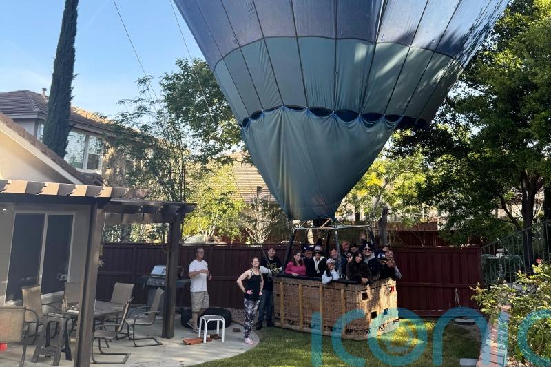 Mind if we drop in? Hot air balloon makes emergency landing in back garden