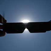 Adequate eye protection must be worn to view the eclipse safely. Picture: Gabriel BOUYS / AFP via Getty Images
